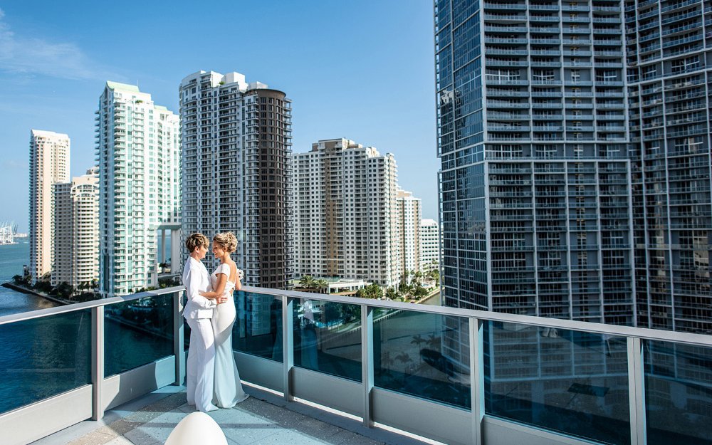 Wedding couple on a balcony at the Kimpton EPIC Hotel