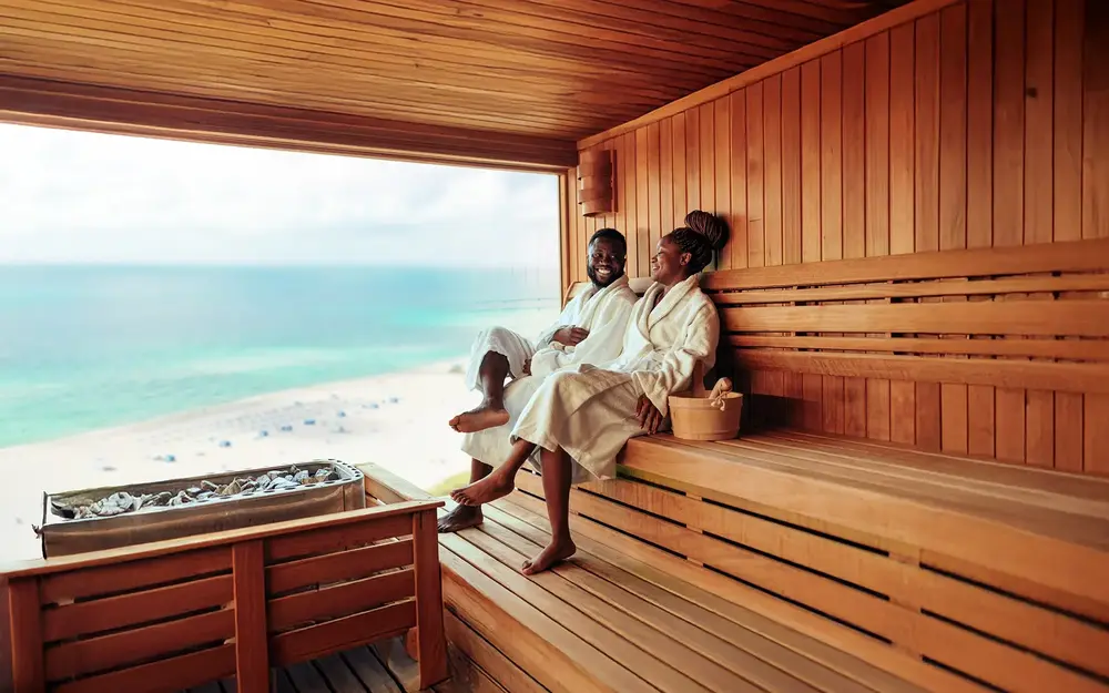 A spa treatment setting with Bamboo room rolled up towels and aromatic candles