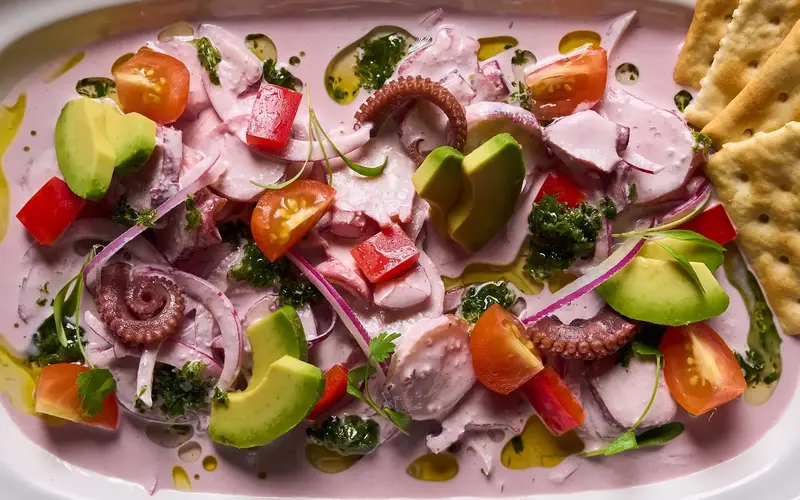 JARANA Aventura octopus and avocado in creamy black olive sauce with crisp soda crackers