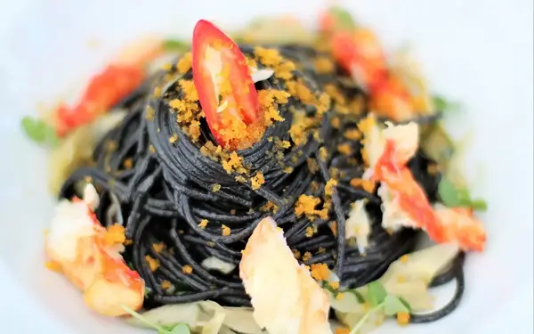 Plate of Squid Ink Torchio with shrimp broth, cilantro and farofa found at Amara at Paraiso