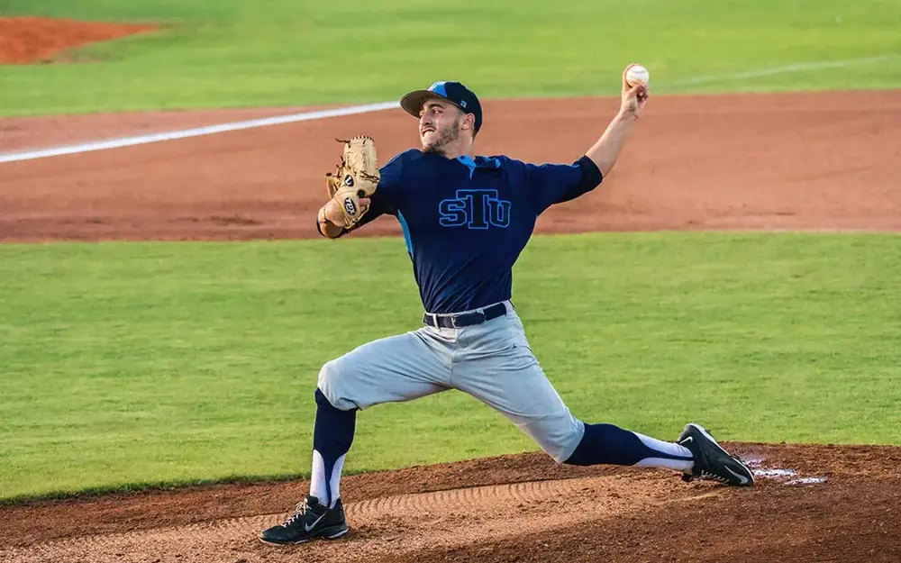 St. Thomas University pitcher throwing a ball