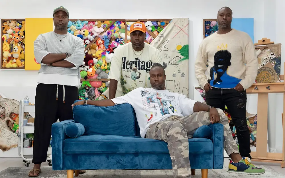 Brandon Clarke sitting on a couch with other artists and artwork