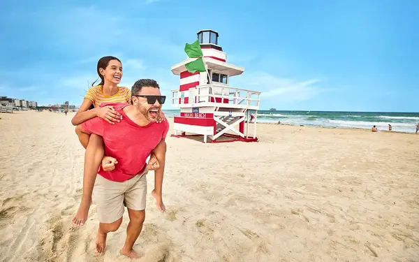 Father and daughter by lighthouse style lifeguard tower