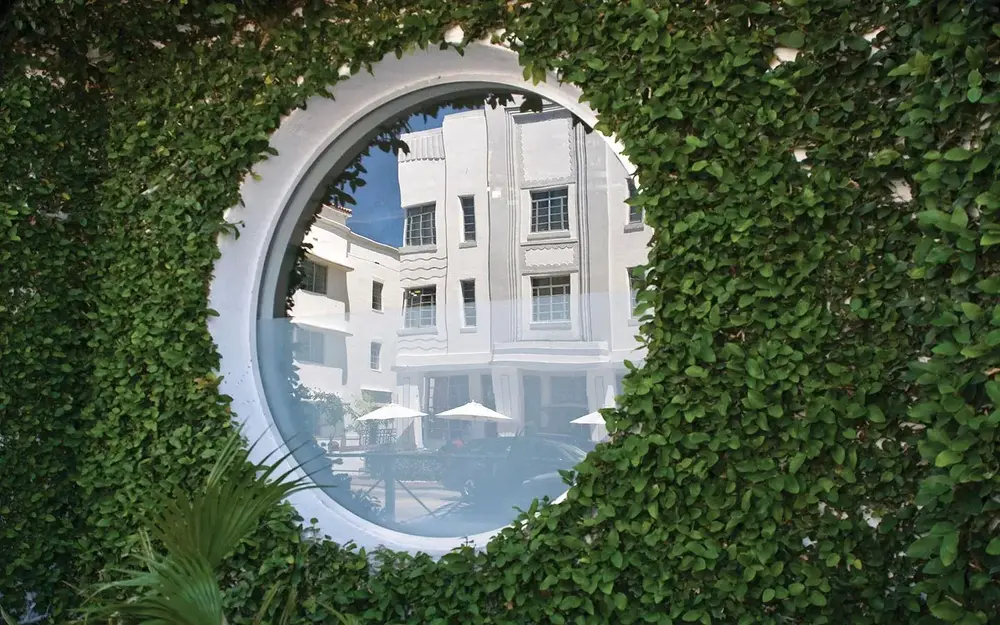 Ocean drive hotels through window shaped like porthole
