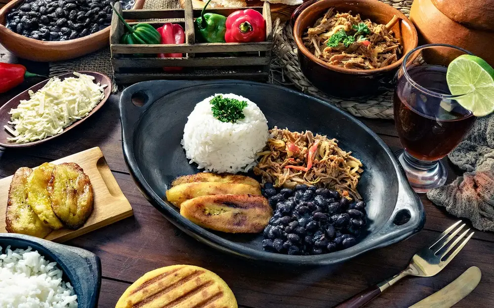 Table spread with rice, beans, meat and plantains