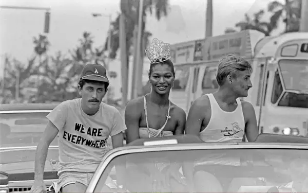 LGBTQ history photo of 3 people supporting gay rights