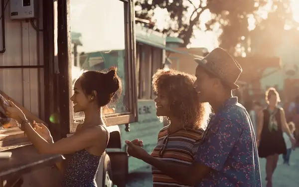 People ordering food at a food truck window