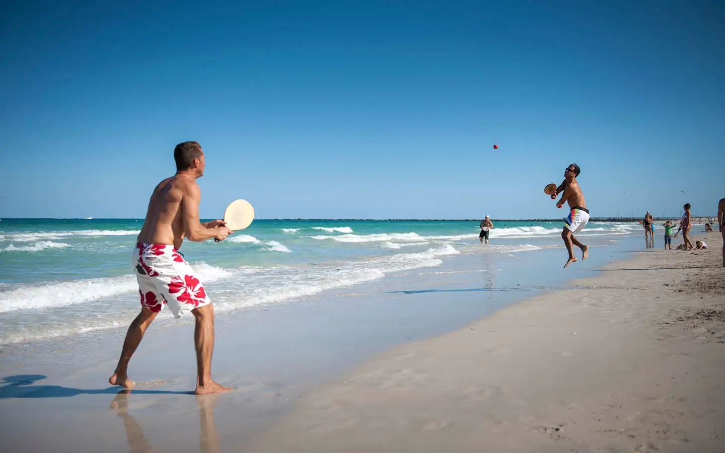 People playing paddleball on the shore of South Beach People playing paddleball on the shore of South Beach