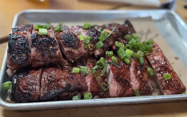 Barbecued brisket topped with chopped scallions at Hometown BBQ