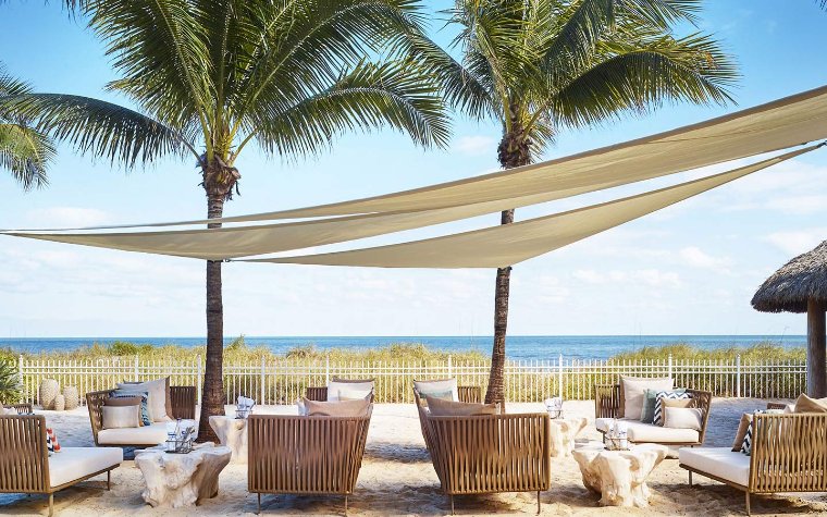 Dune Burgers on the Beach's dining area & ocean background Seating area on the sand at Dune Burgers on the Beach