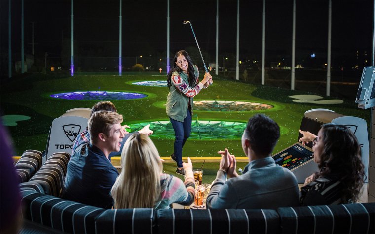 Family playing golf at Topgolf