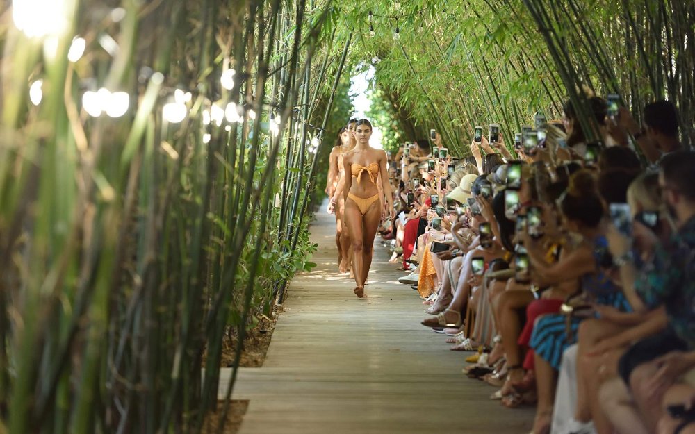Miami Beach Swimsuit Fashion Shows models walking under a bamboo arch