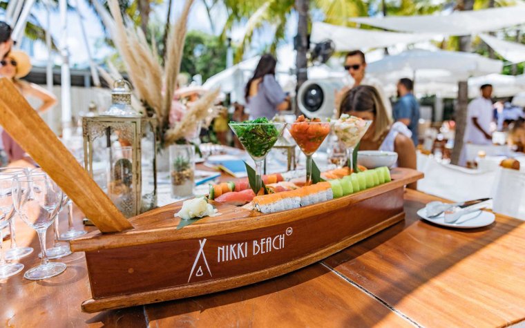 Assorted sushi rolls in a wooden boat at Nikki Beach