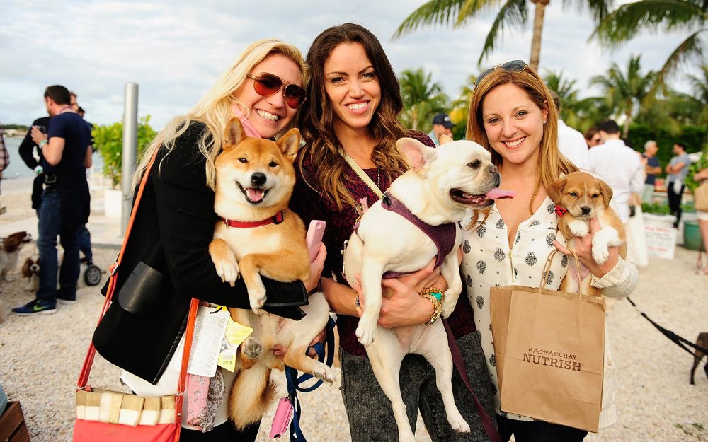 Women posing with their dogs at Yappy Hour