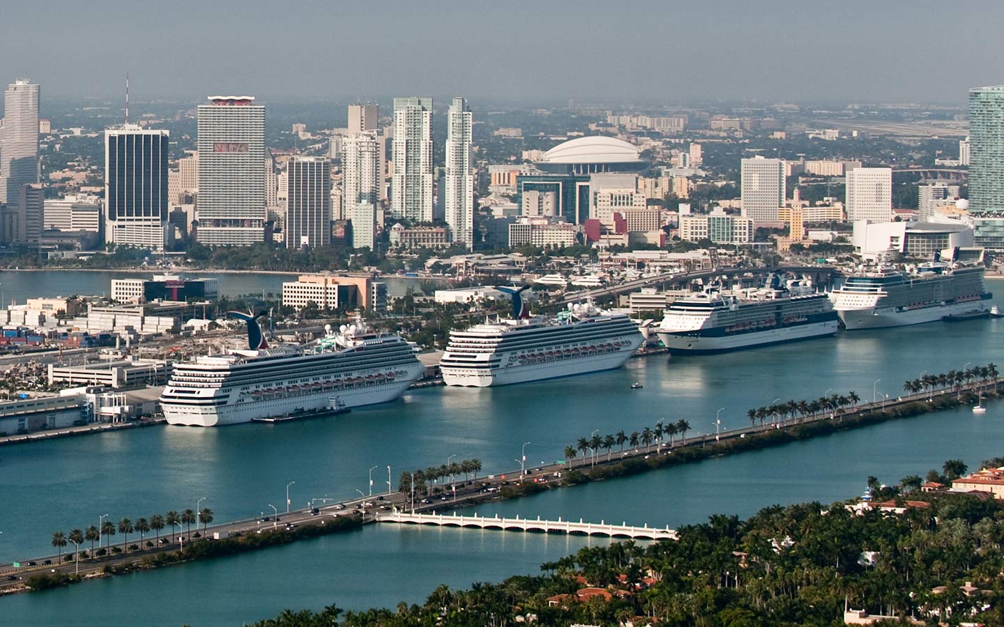 Cruise ships docked at PortMiami with Downtown Miami skyline in background