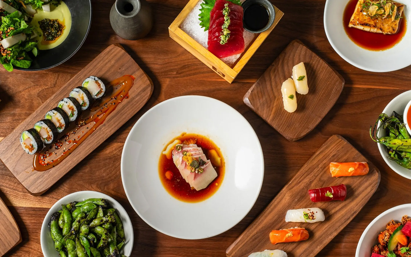 Variety of dishes elegantly arranged on a table at Uchiko