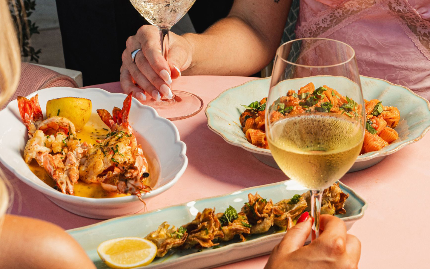 Spread at Casadonna with appetizer, pasta, and prawns dish