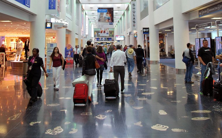 People with luggage at Miami International Airport People with luggage at Miami International Airport