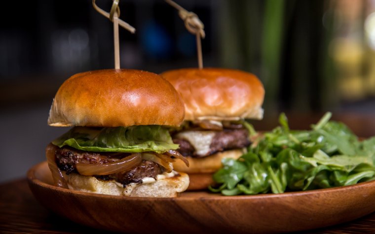 Wagyu beef sliders served on toasted buns Wagyu beef sliders served on toasted buns