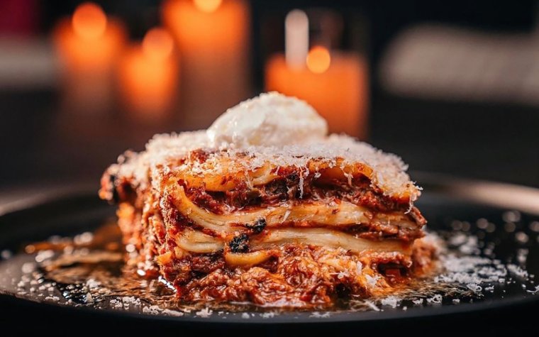 A hearty slice of lasagna with layers of rich meat,cheese and perfectly cooked pasta A hearty slice of lasagna with layers of rich meat,cheese and perfectly cooked pasta