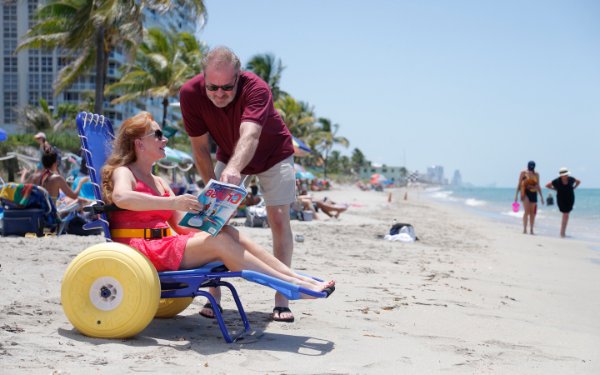 Dame sur la joie sur le Beach Fauteuil roulant, par Special Needs Group® Special Needs at Sea®