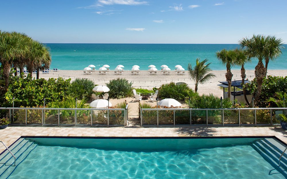 Pool by the beach at Solé Miami with oceanfront view