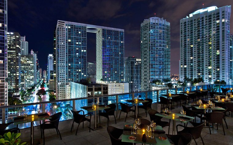 Balcony seating area at Area 31 restaurant at night with city lights Balcony seating area at Area 31 restaurant at night with city lights