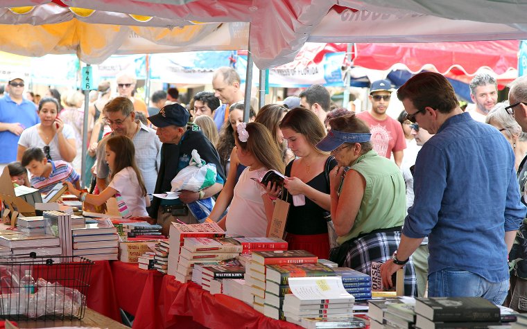 Browsing books in a tent Browsing books in a tent