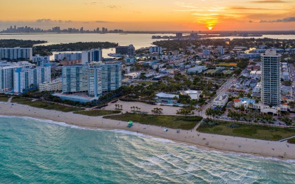 Aerial view of Miami Beach Bandshell from over ocean with sunset in background