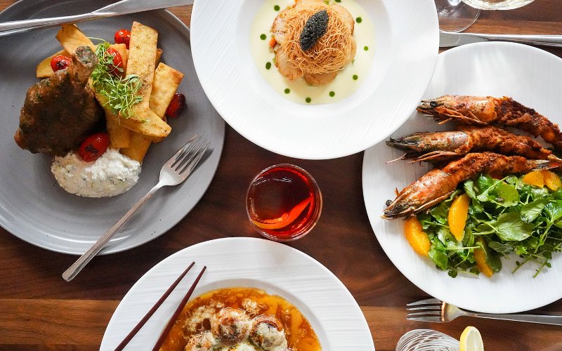 Variety of plated meals arranged at Sérêvène Miami