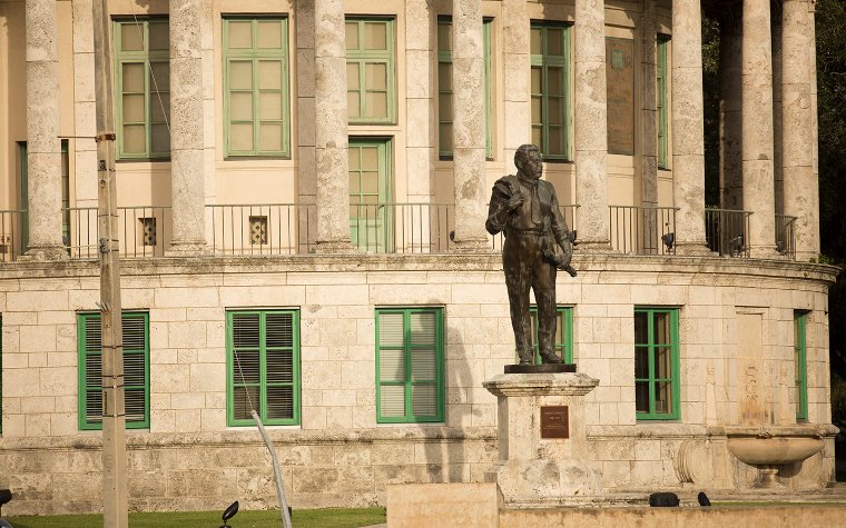 Coral Gables City Hall with a statue of George Merrick in front