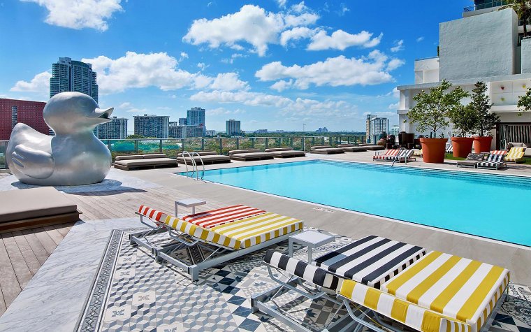 South pool area at SLS Brickell with lounge seating and duck art sculpture South pool area at SLS Brickell with lounge seating and duck art sculpture