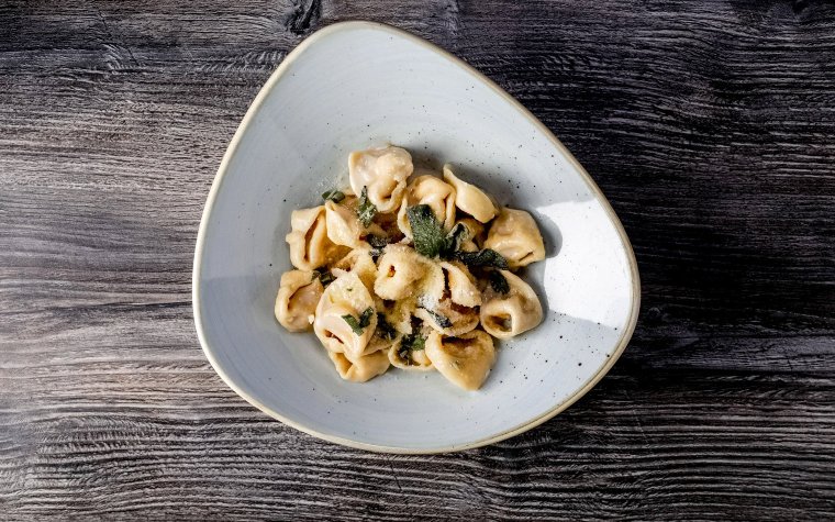 Platted dish of Tortellini Alla Panna at Via Emilia 9