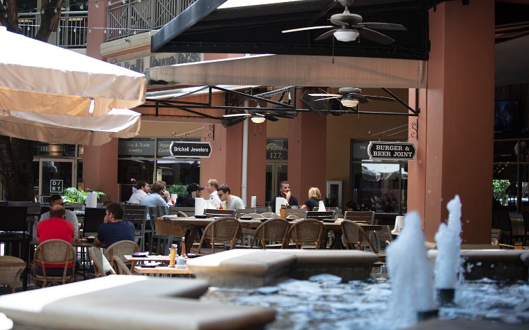 People sitting outside dining area at Mary Brickell Village