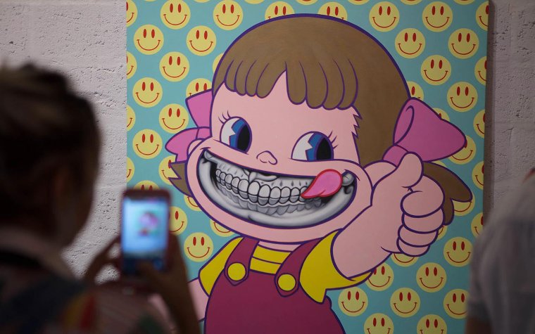 Colorful mural of a girl with big teeth at Wynwood Walls