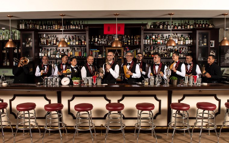 Cafe La Trova Cantineros standing in front of the bar area Cafe La Trova Cantineros standing in front of the bar area