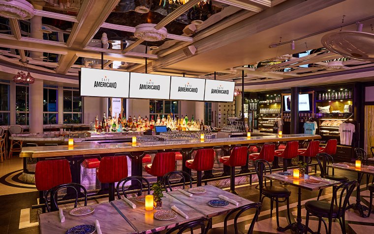 Interior of Cafe Americano on Ocean Drive with dining tables and bar seating