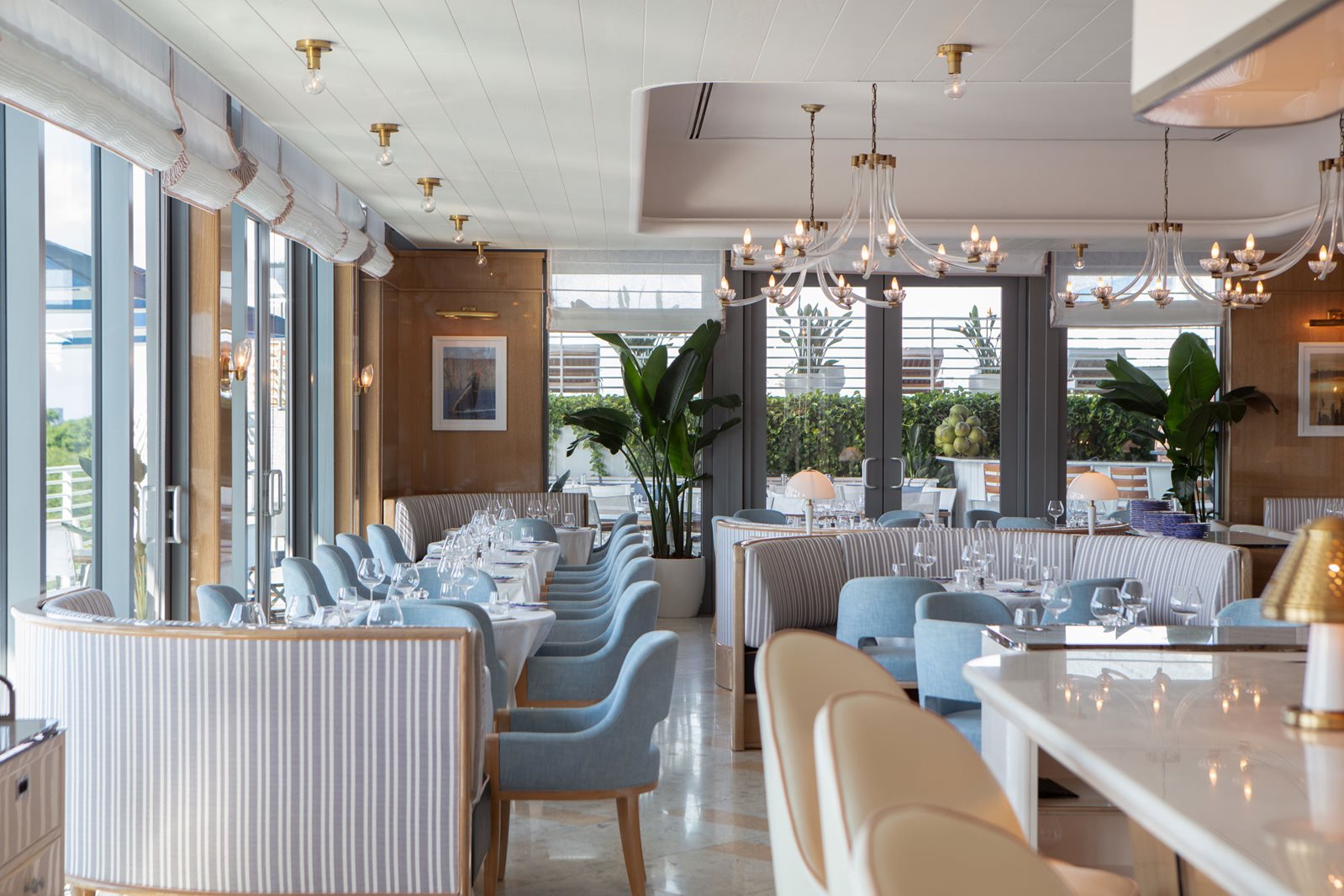 Chandeliers glow over Bellini's dining room