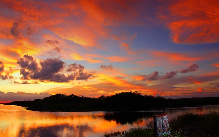 Sunset over the Everglades with colorful sky reflecting on the water