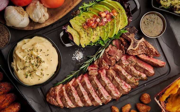 T-bone steak and sides at El Toro Loco Steakhouse T-bone steak and sides at El Toro Loco Steakhouse