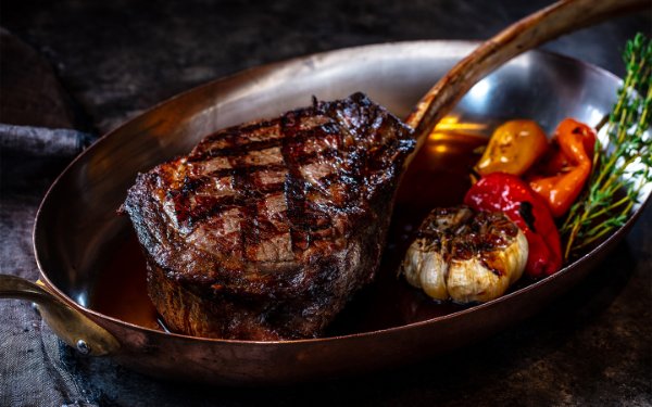 Gebratenes Steak und gerösteter Knoblauch bei Bourbon Steak