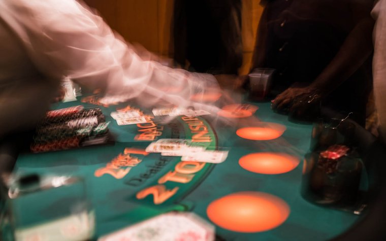Dealer in the casino taking bets Dealer in the casino taking bets