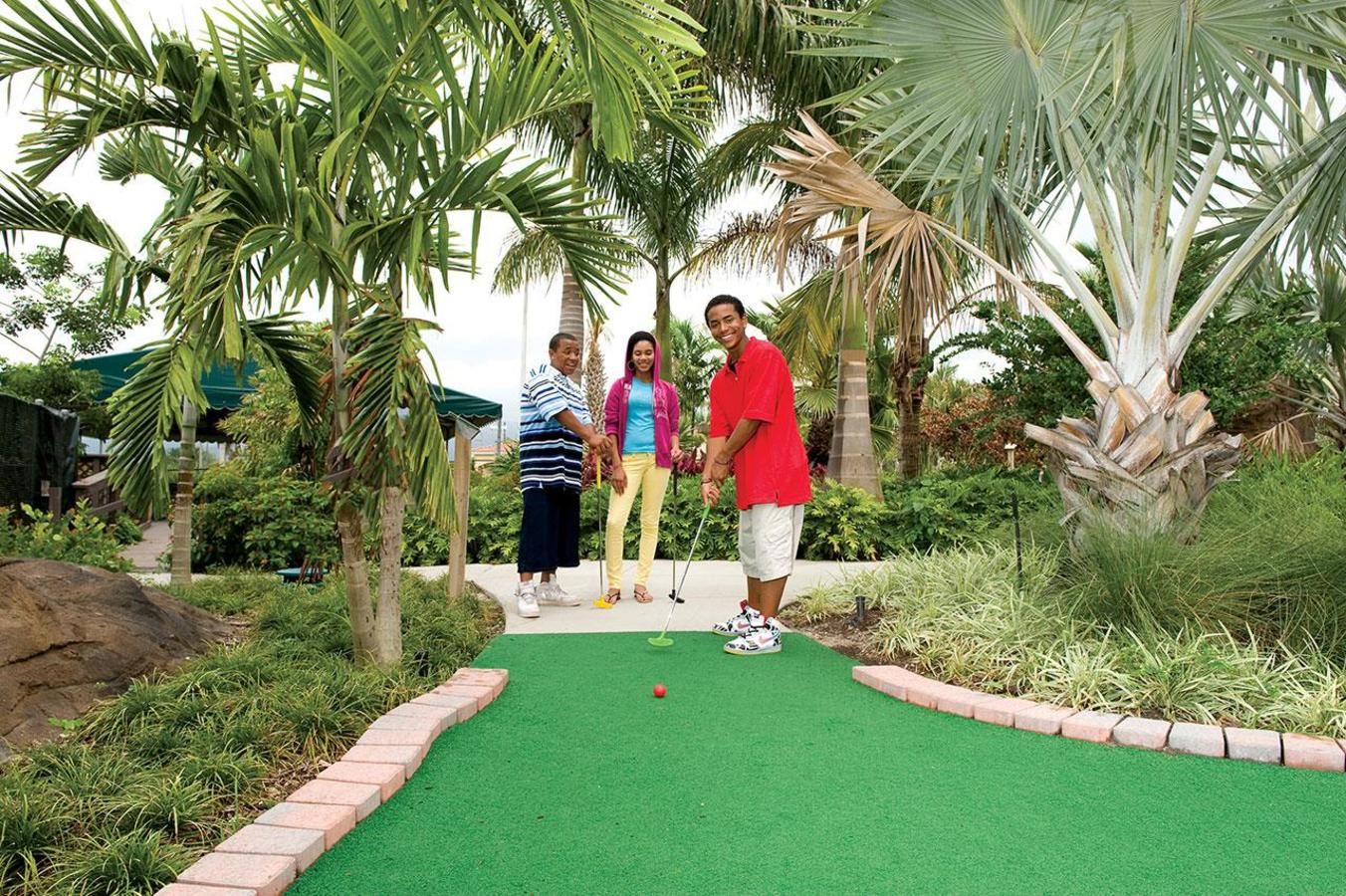 Family playing at Palmetto Mini Golf Family playing at Palmetto Mini Golf