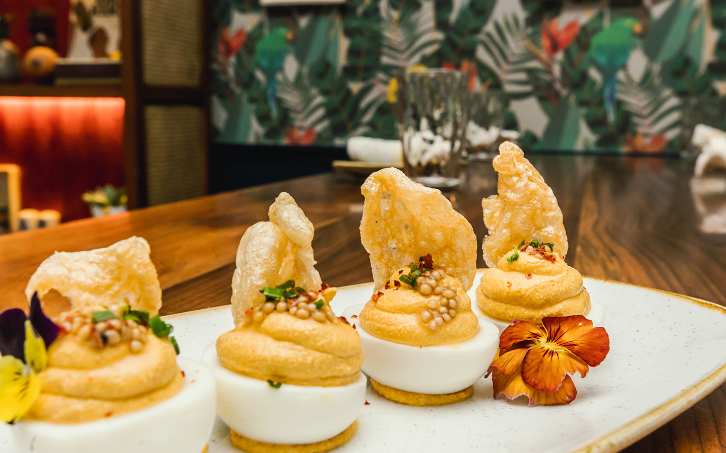 Plate of deviled eggs topped with crispy cracklings at Red Rooster Plate of deviled eggs topped with crispy cracklings at Red Rooster