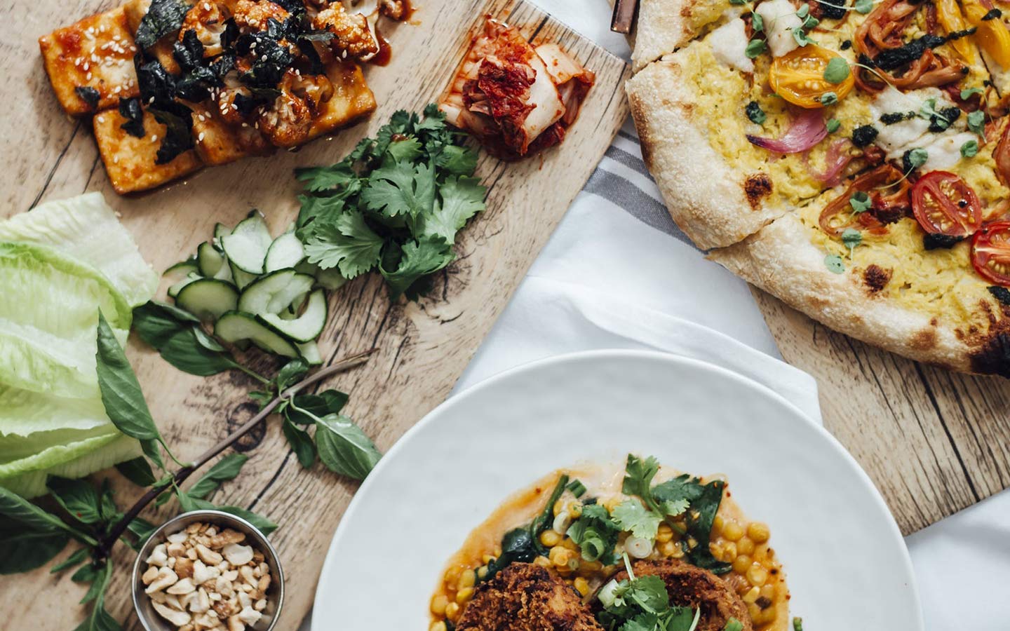 A variet of dishes served on carving boards at Planta