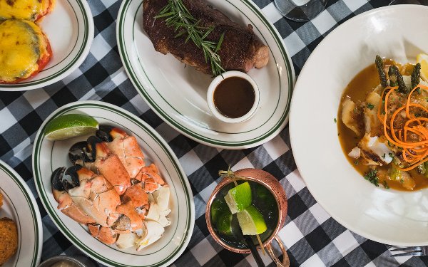 Table spread at Joe's Stone Crab featuring steak and stone crab claws 
