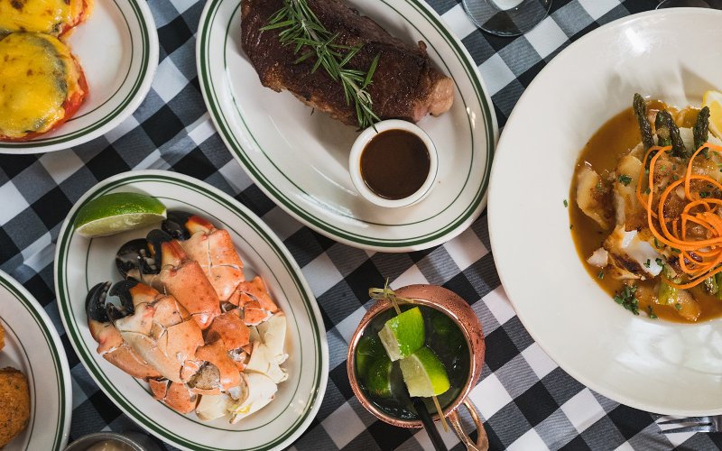 Table spread at Joe's Stone Crab featuring steak and stone crab claws 