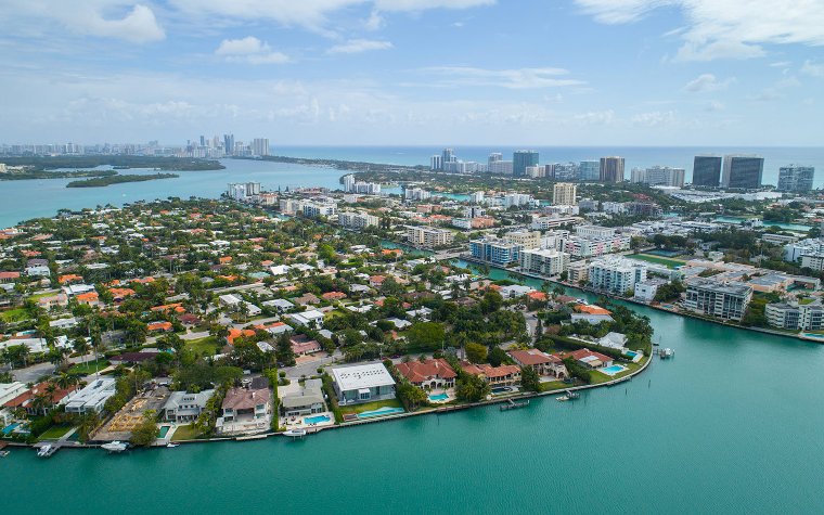 Aerial view of Bay Harbor Islands with waterfront homes, canals and turquoise waters Aerial view of Bay Harbor Islands with waterfront homes, canals and turquoise waters