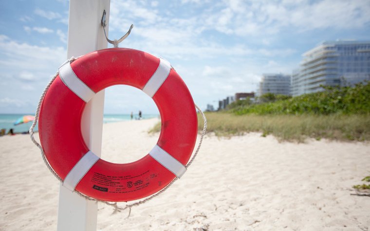 Surfside walking path with life-preserver