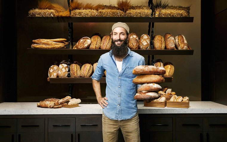 Zak in front of a bread display